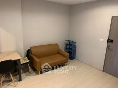 Modern minimalist living room with brown sofa and dining table