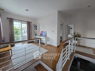 Spacious modern living area with balcony and natural light, perfect for relaxation.