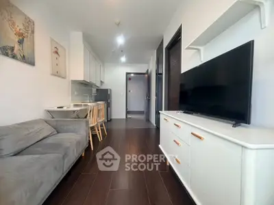 Modern living room with sleek furniture and open kitchen layout in a stylish apartment.
