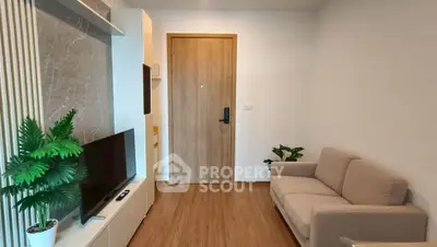 Modern living room with sleek TV setup and cozy sofa, perfect for relaxation.