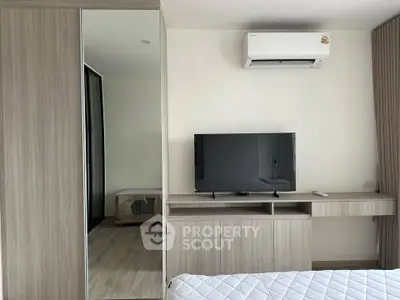 Modern bedroom with sleek furniture and air conditioning unit, perfect for comfortable living.