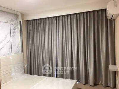 Modern bedroom with elegant curtains and air conditioning unit