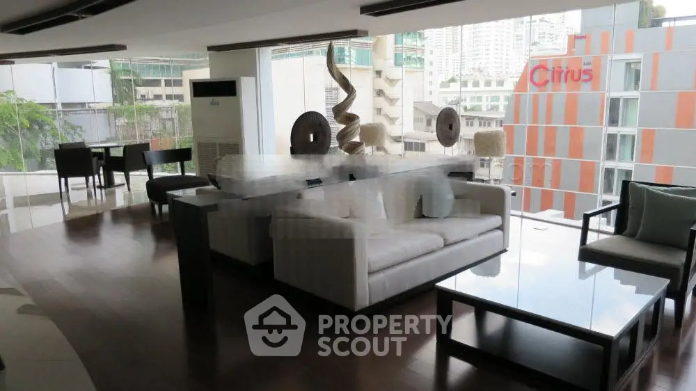 Luxurious modern living room with city view, elegant furniture, and stylish decor in high-rise apartment.