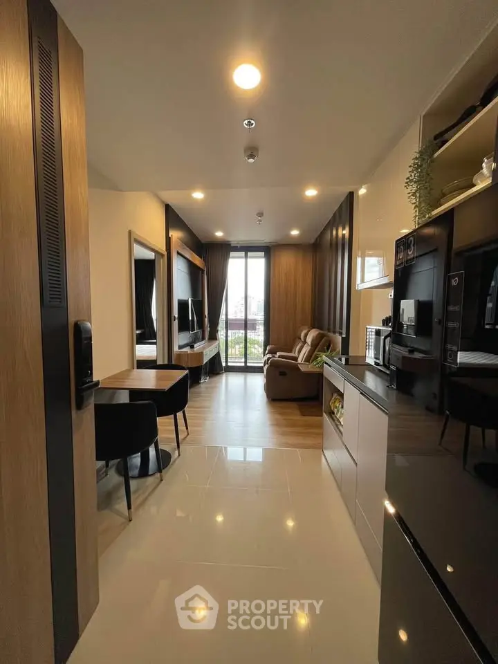 Modern open-plan living room with sleek kitchen and city view balcony