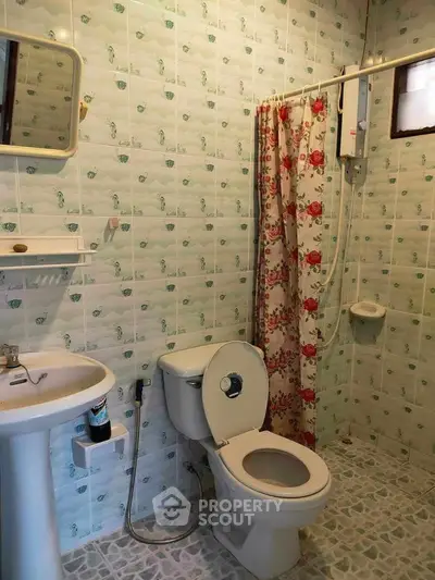 Charming bathroom with floral shower curtain and vintage tile design