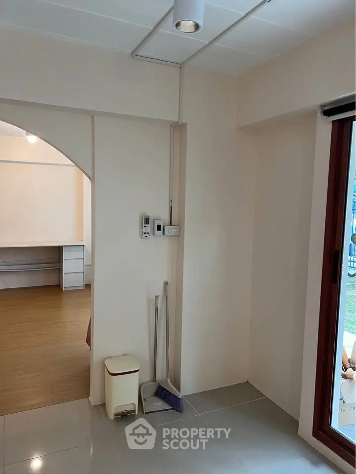 Spacious interior with modern flooring and large window for natural light