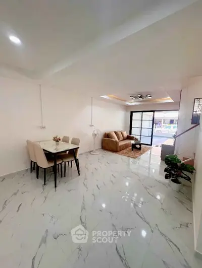 Spacious living room with elegant marble flooring and modern furniture