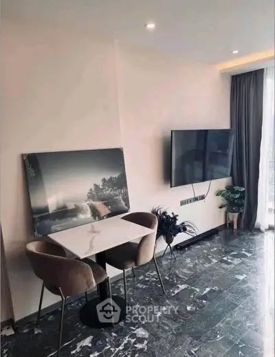 Modern living room with marble flooring, wall-mounted TV, and elegant dining setup.