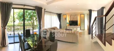 Spacious modern living room with large windows and elegant decor