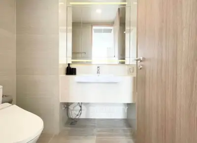 Modern bathroom with sleek fixtures and minimalist design in a contemporary apartment.