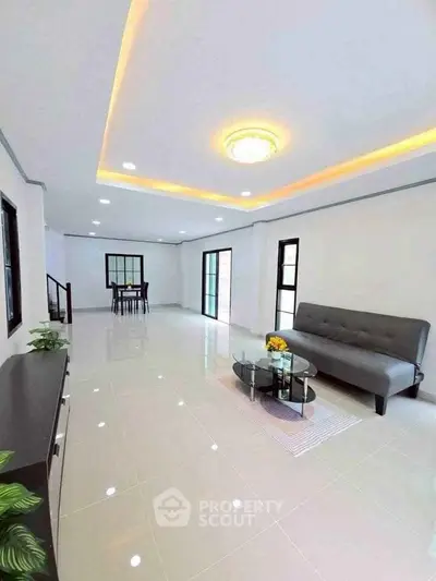 Spacious modern living room with sleek design and elegant lighting