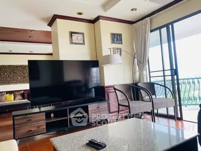 Spacious living room with modern TV and balcony view in luxury apartment.