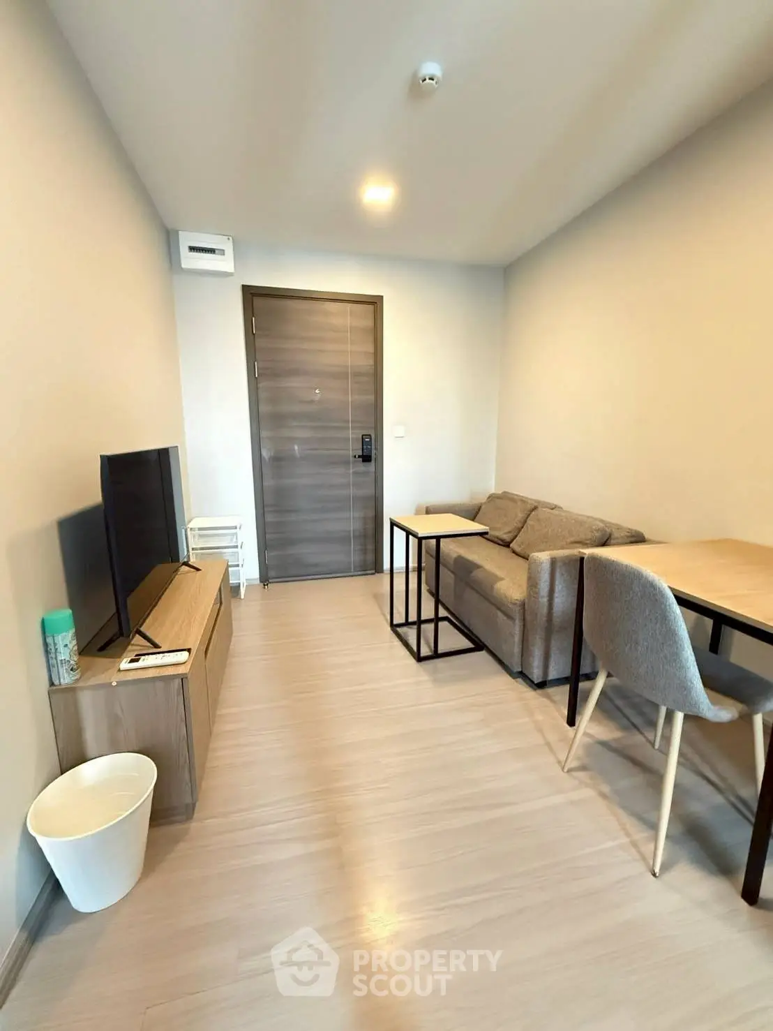 Modern living room with sleek furniture and wooden flooring, perfect for cozy urban living.