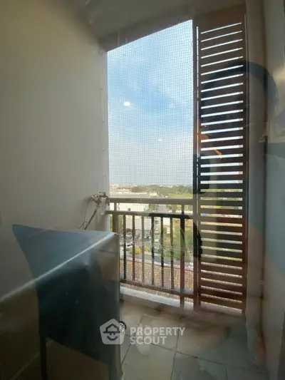 Charming balcony with scenic view and stylish wooden shutters, perfect for relaxation.