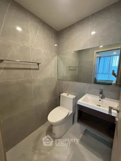 Modern bathroom with sleek design and elegant fixtures in a contemporary apartment.