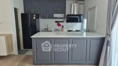 Modern kitchen with sleek cabinetry and gas stove in stylish apartment