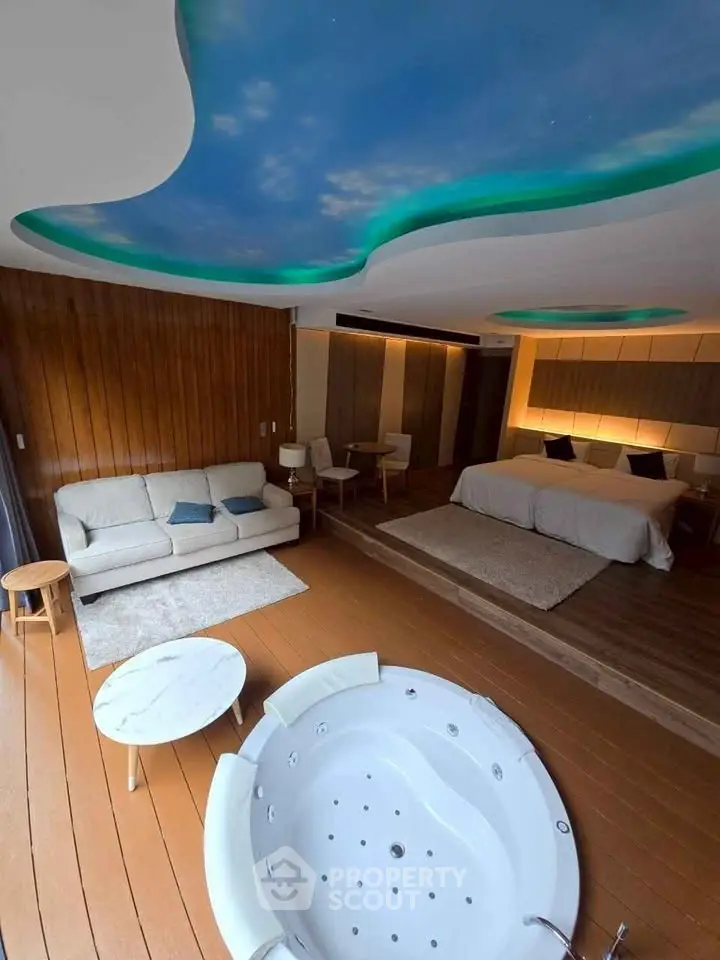 Luxurious bedroom with jacuzzi and sky-themed ceiling, featuring modern decor and cozy ambiance.