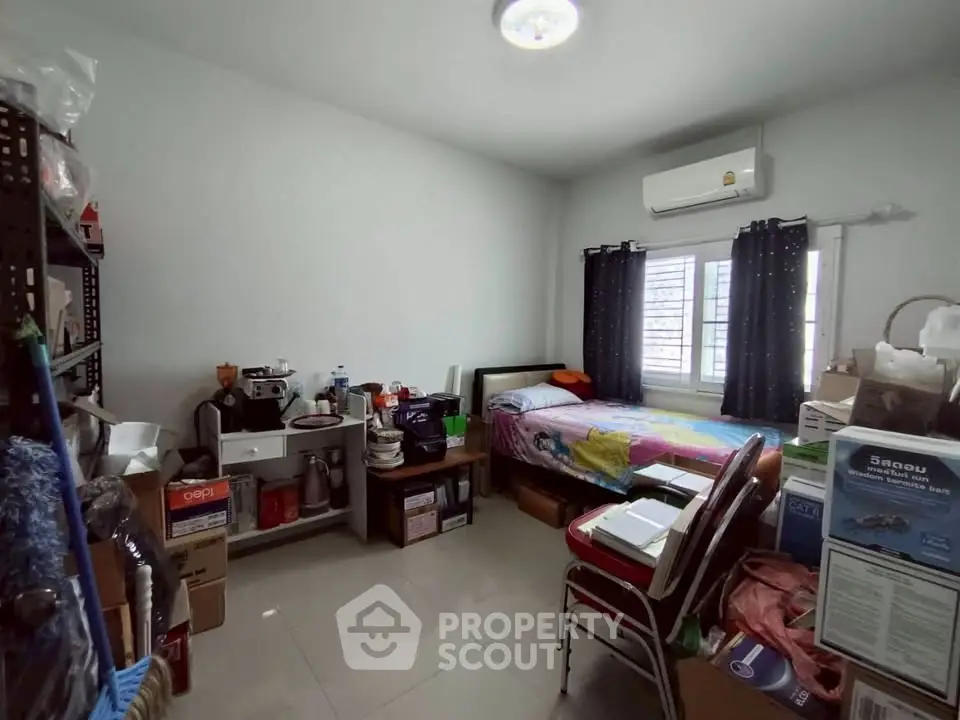 Cozy bedroom with air conditioning and ample storage space, perfect for comfortable living.