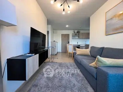 Modern living room with stylish decor and open kitchen layout in a contemporary apartment.