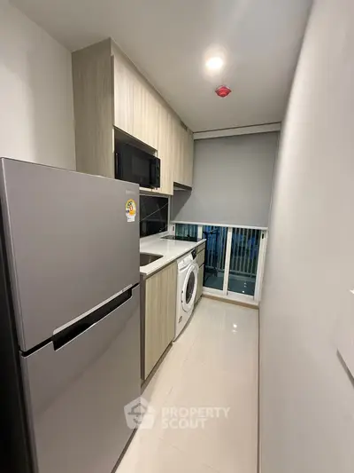 Modern kitchen with sleek appliances and compact design