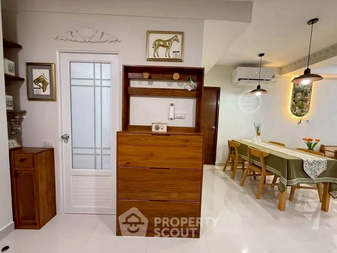 Charming dining area with wooden furniture and elegant decor in a cozy home setting.