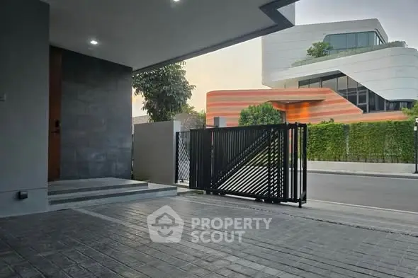 Modern residential entrance with sleek gate and contemporary architecture