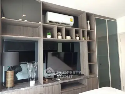 Modern bedroom with built-in shelving and air conditioning unit