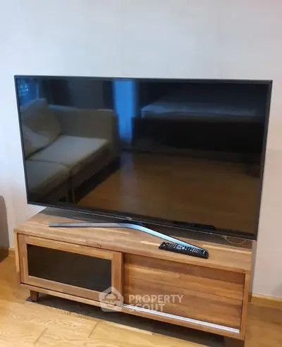 Modern living room with sleek TV and stylish wooden cabinet