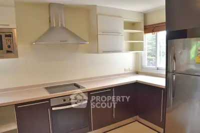 Modern kitchen with sleek cabinetry and stainless steel appliances in a bright, airy space.