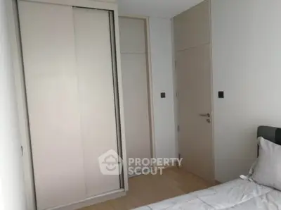 Modern minimalist bedroom with sleek wardrobe and neutral tones