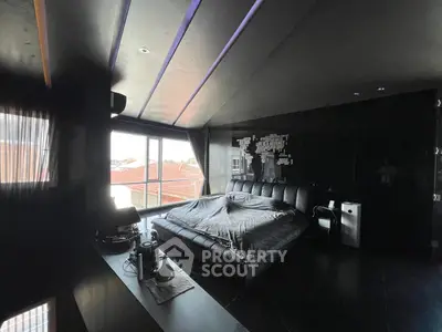 Luxurious dark-themed bedroom with large windows and modern decor