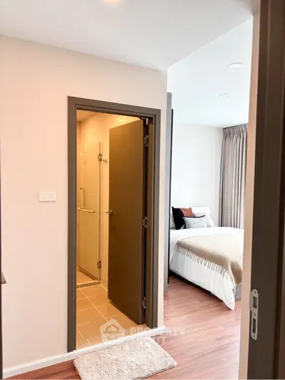 Modern bedroom with ensuite bathroom, featuring elegant decor and cozy ambiance.