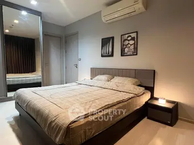 Modern bedroom with stylish decor and air conditioning in a cozy apartment.