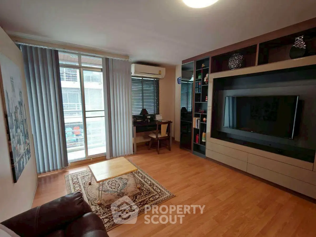 Spacious living room with modern decor and large window for natural light