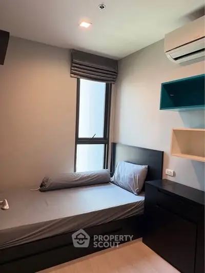 Cozy bedroom with modern design and air conditioning, perfect for urban living.