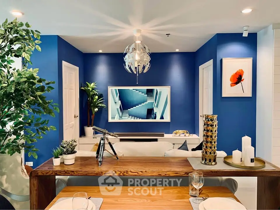 Modern living room with blue accent wall and stylish decor