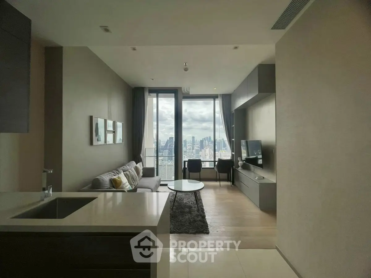 Modern living room with city view, sleek furniture, and open layout.