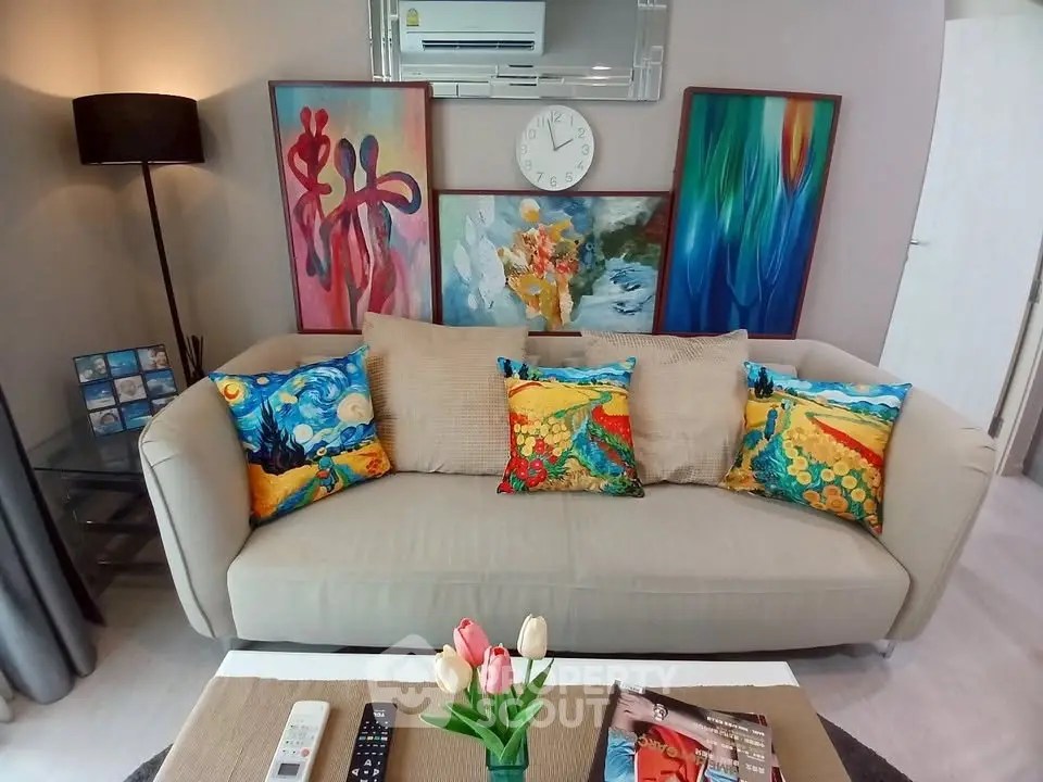 Stylish living room with vibrant art and cozy sofa, perfect for modern living.