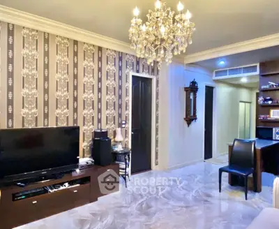 Luxurious living room with elegant chandelier and stylish wallpaper, perfect for modern living.