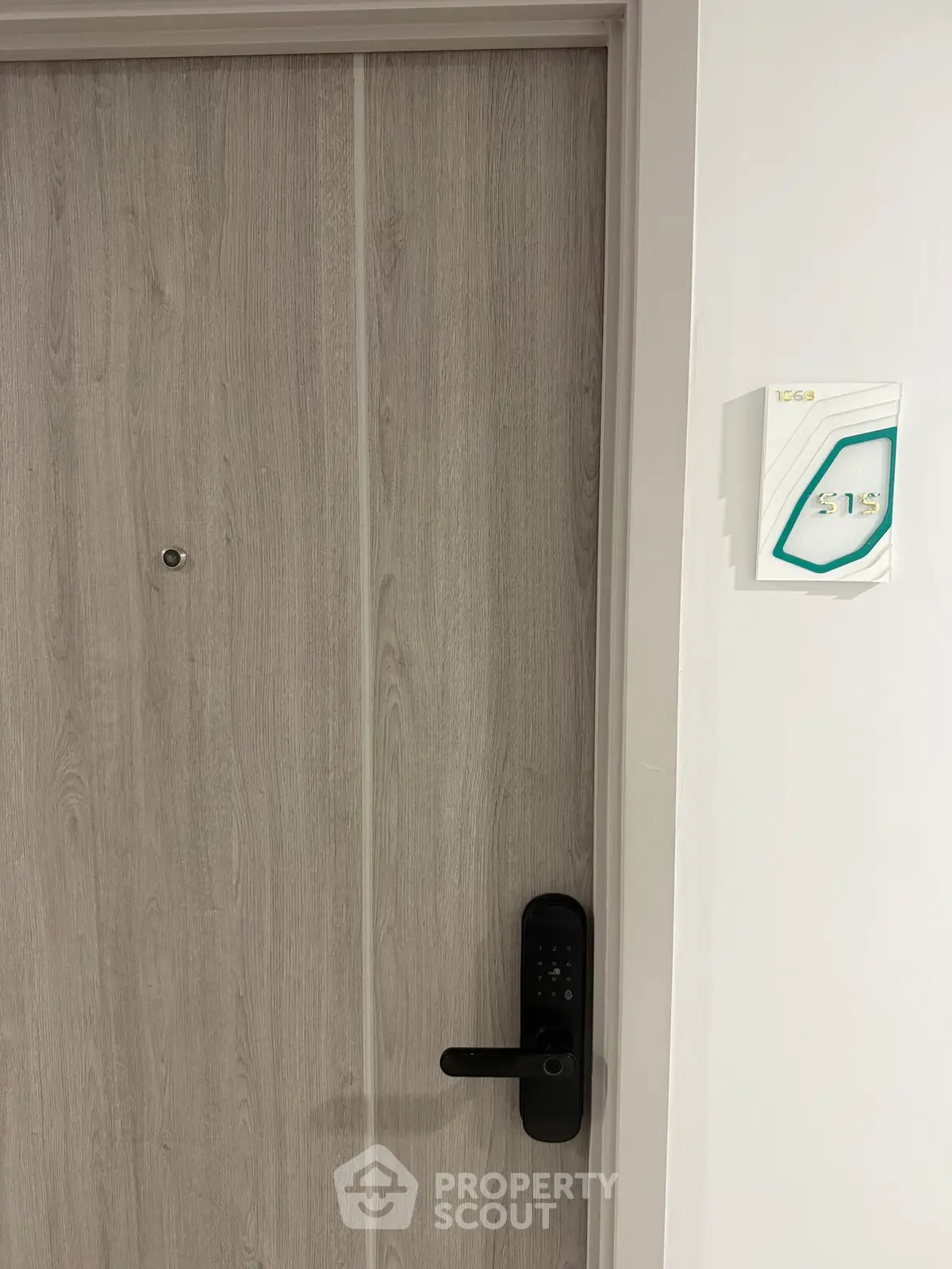 Modern apartment door with electronic lock and room number 513, showcasing secure entry features.