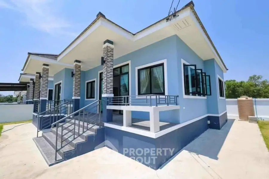 Stunning modern blue house with elegant exterior design and spacious front steps.