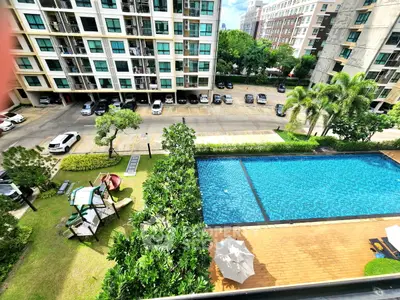 Stunning apartment view with pool, playground, and lush greenery in a modern residential complex.