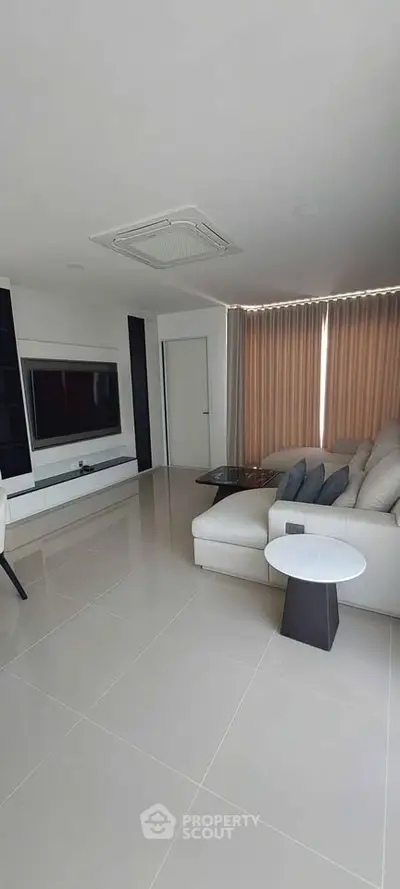 Spacious modern living room with sleek design and large windows for natural light.
