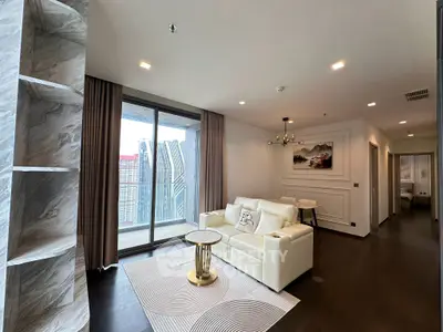 Luxurious modern living room with elegant decor and stunning city view from large windows.