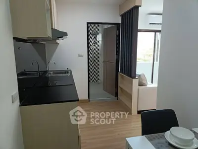 Modern apartment kitchen with sleek black countertops and open layout