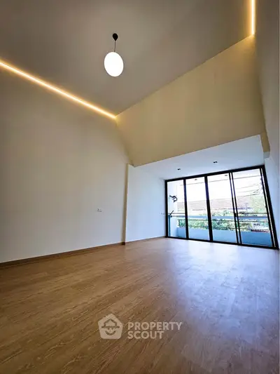 Spacious modern living room with high ceiling and large windows