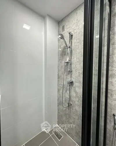 Modern bathroom with sleek shower design and elegant tile work.