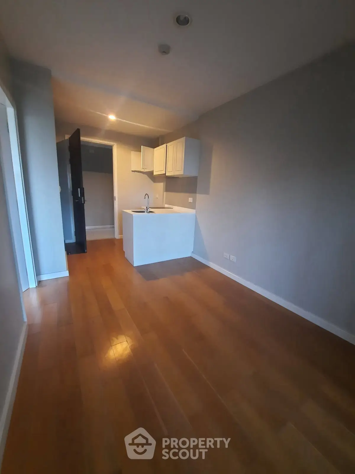 Modern apartment with sleek kitchen and wooden flooring, perfect for urban living.