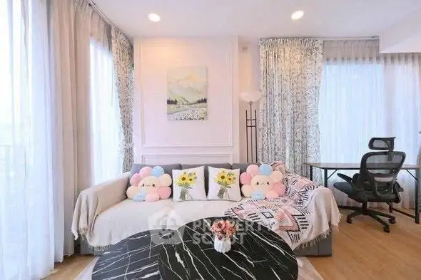 Charming living room with cozy sofa and stylish decor, perfect for relaxation and work-from-home setup.