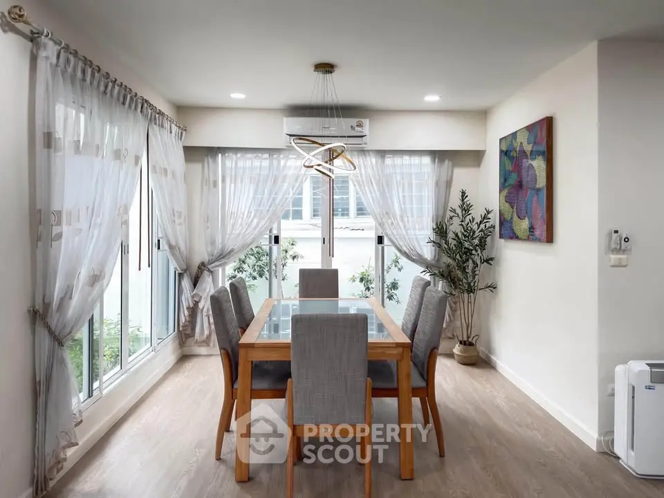 Elegant dining room with modern decor and large windows for natural light